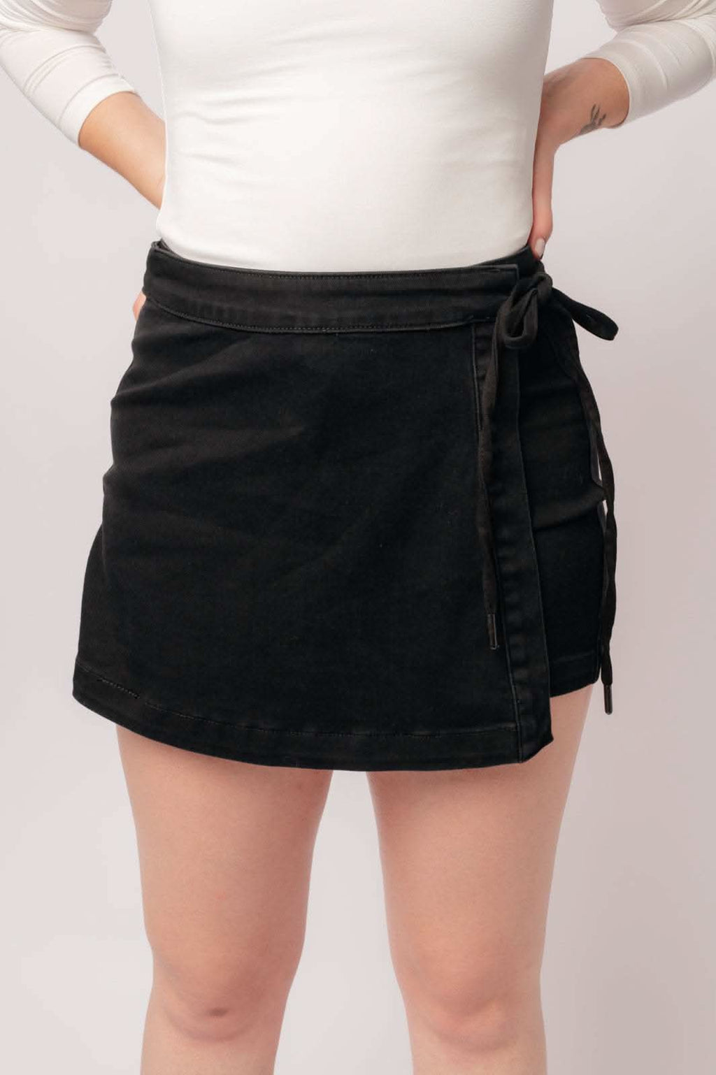 Bentli High Rise Side Tie Denim Skort in Black in - Denim photo