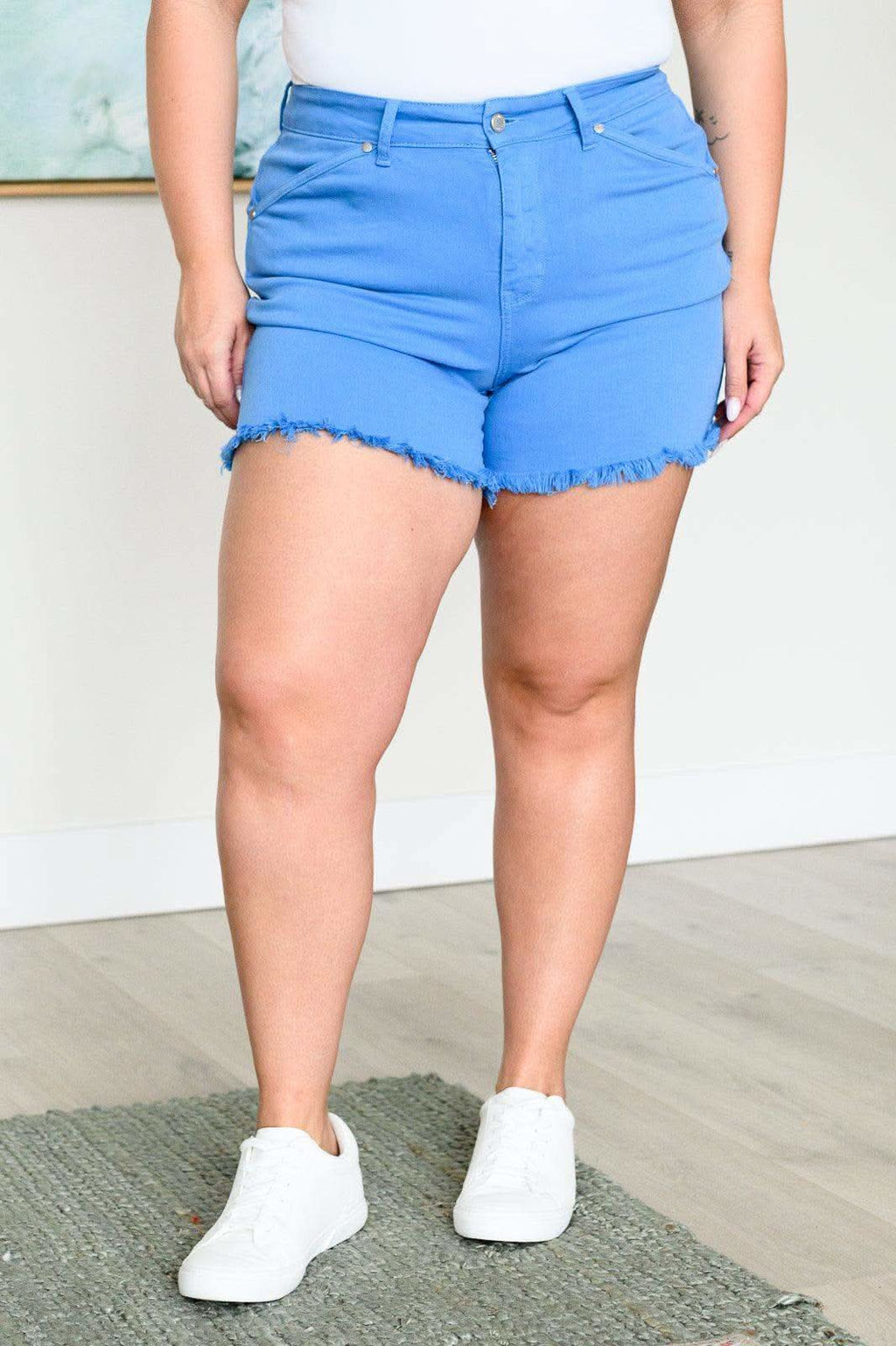 Celeste Mid Rise Shield Pocket Cutoff Shorts in Sky Blue in - Denim photo