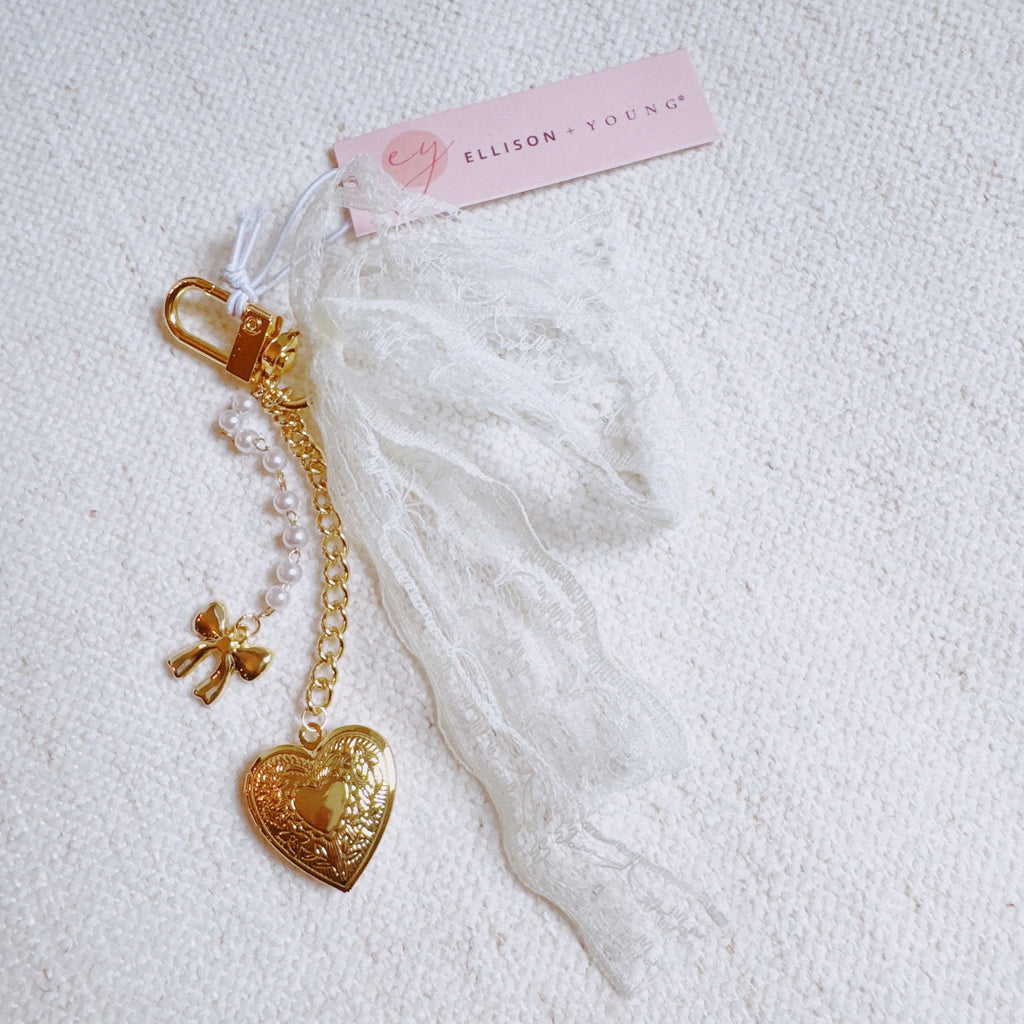 Lace & Love Heart Bag Charm – White Bow with Gold Heart | Romantic Chic in - Jewelry photo