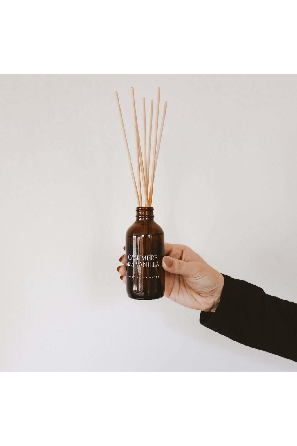 Sweet Water Decor Cashmere and Vanilla Amber Reed Diffuser in - Reed Diffusers photo