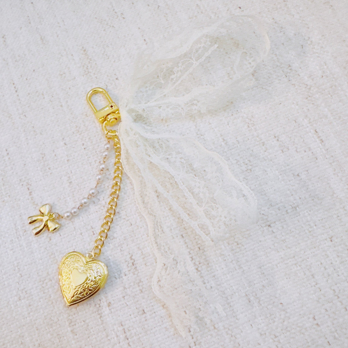 Lace & Love Heart Bag Charm – White Bow with Gold Heart | Romantic Chic in - Jewelry photo