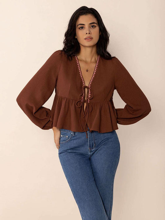 Peplum Tied V-Neck Long Sleeve Blouse in - photo
